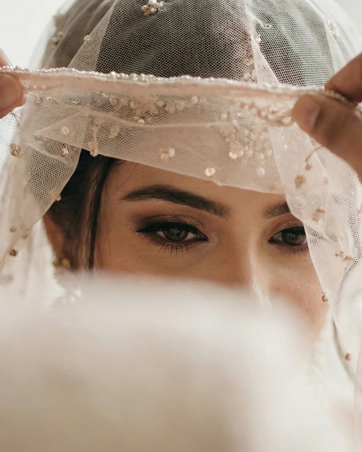 A groom lifting his bride's veil to see her for the first time